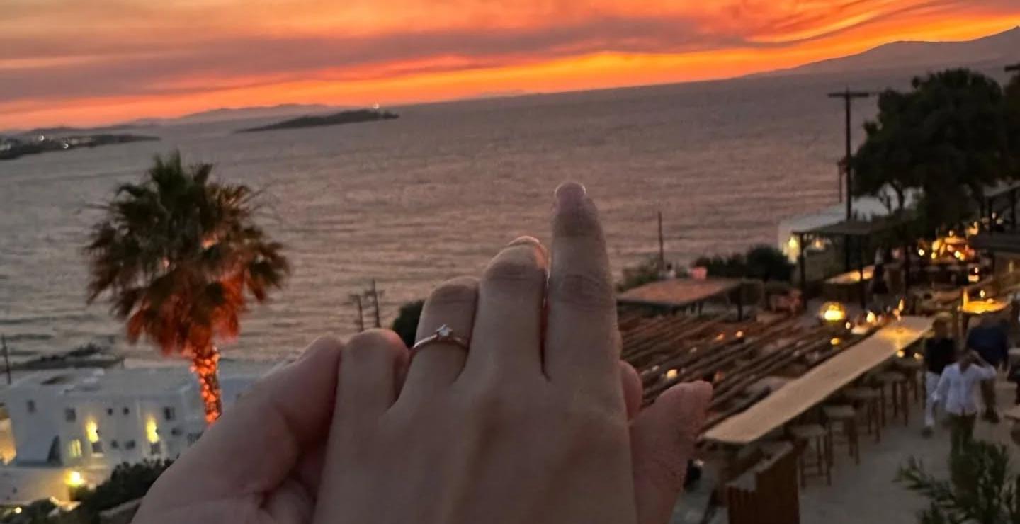 a person with a sunset in the background