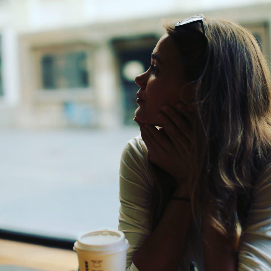 a woman holding a cup of coffee