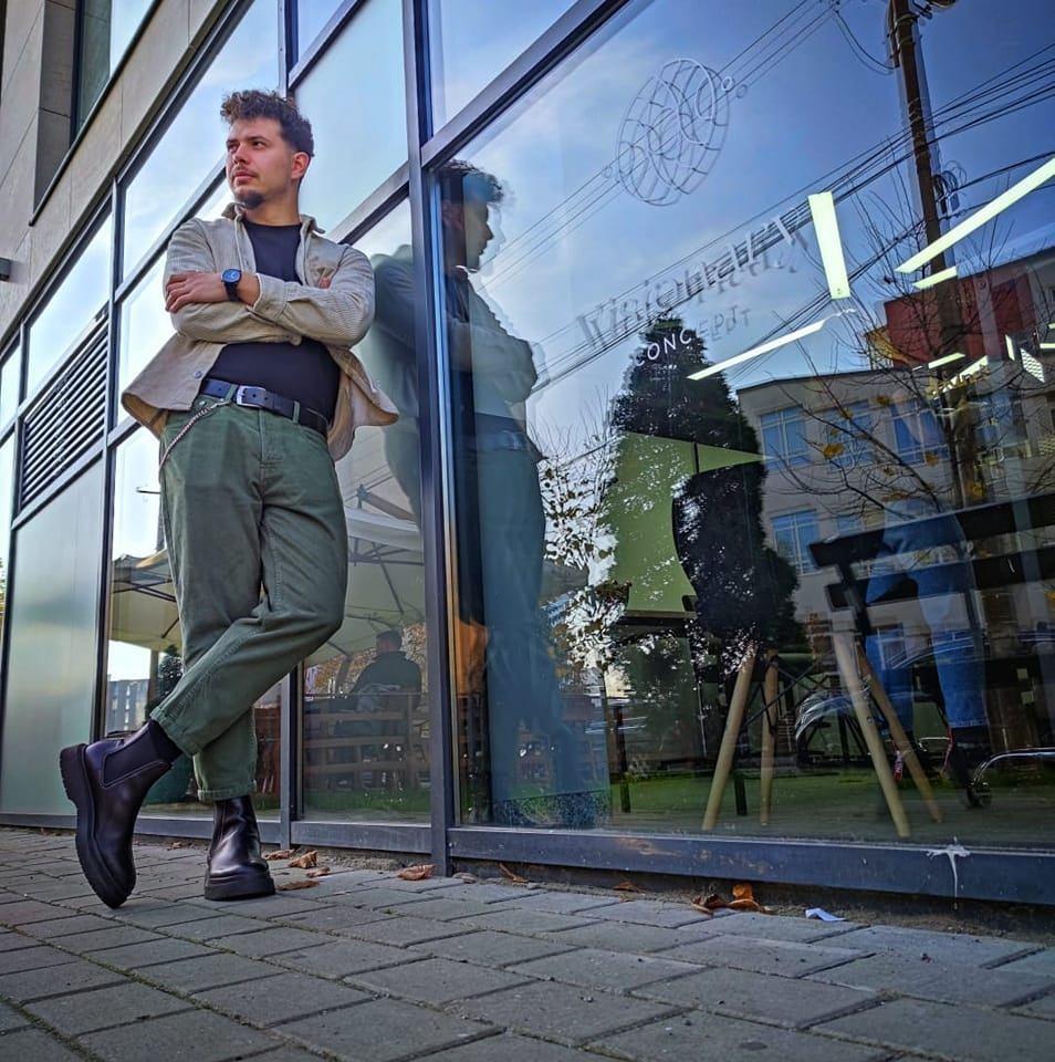 a man standing on a sidewalk