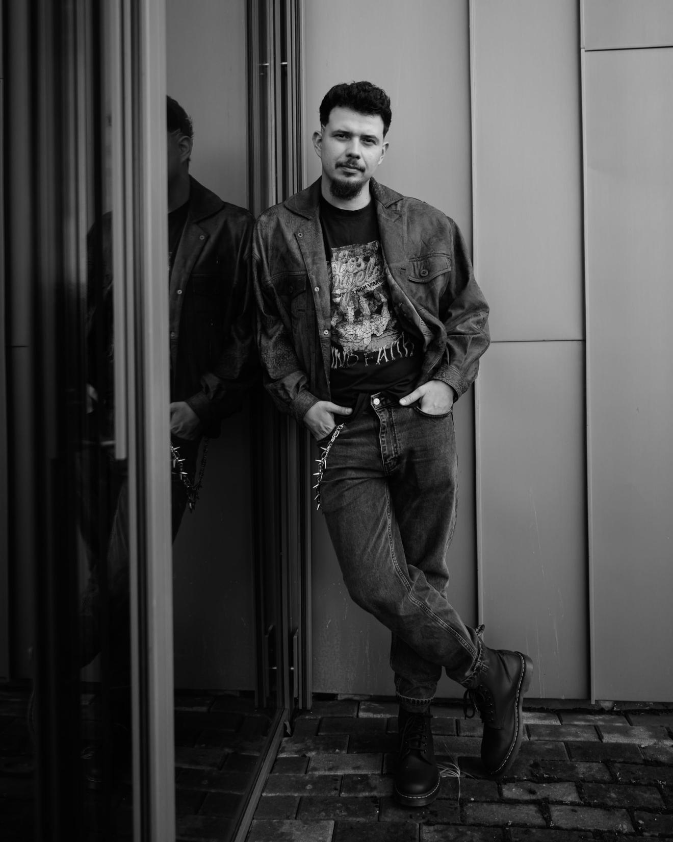 a man standing in front of a mirror posing for the camera
