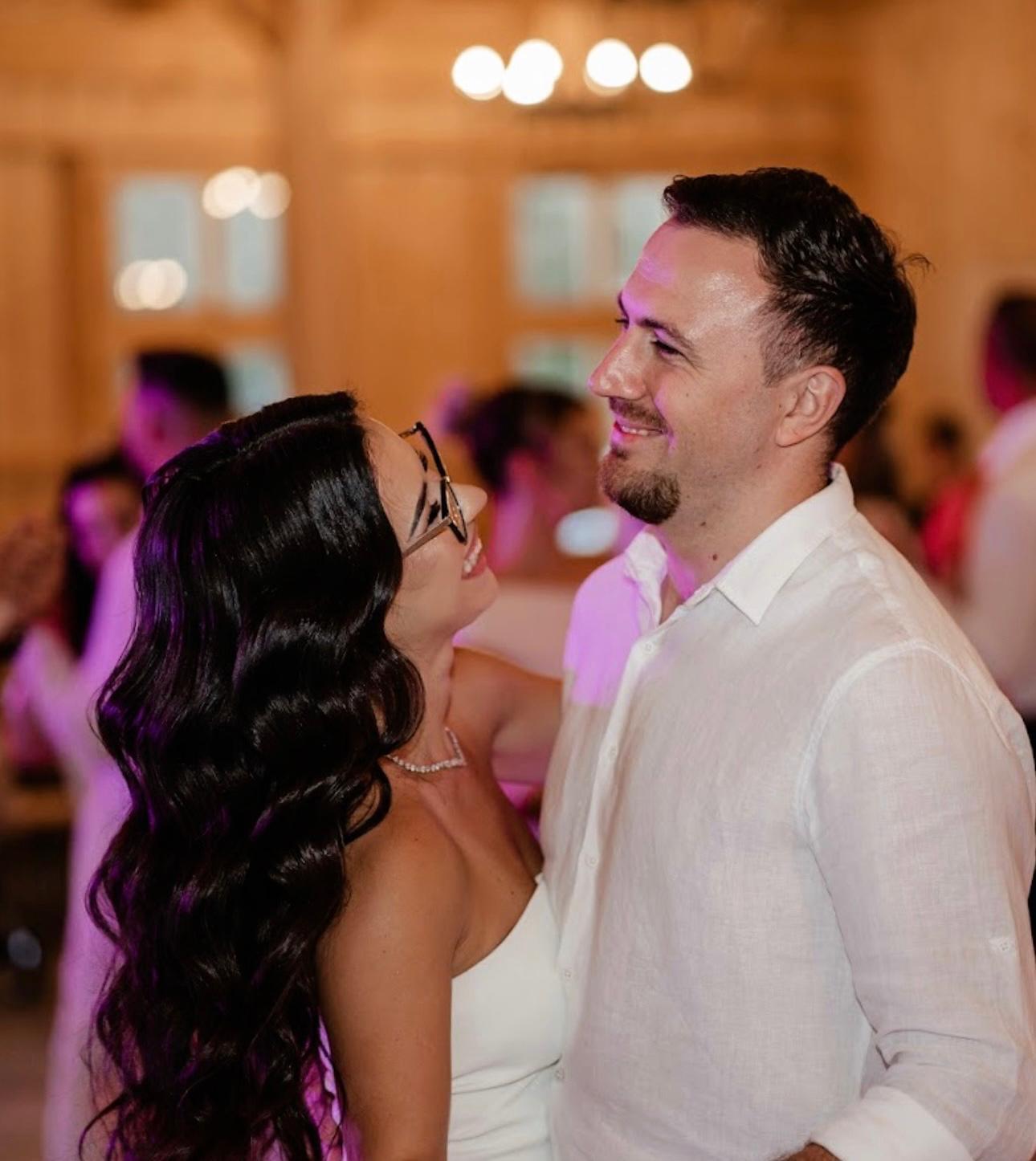 a man and a woman looking at the camera