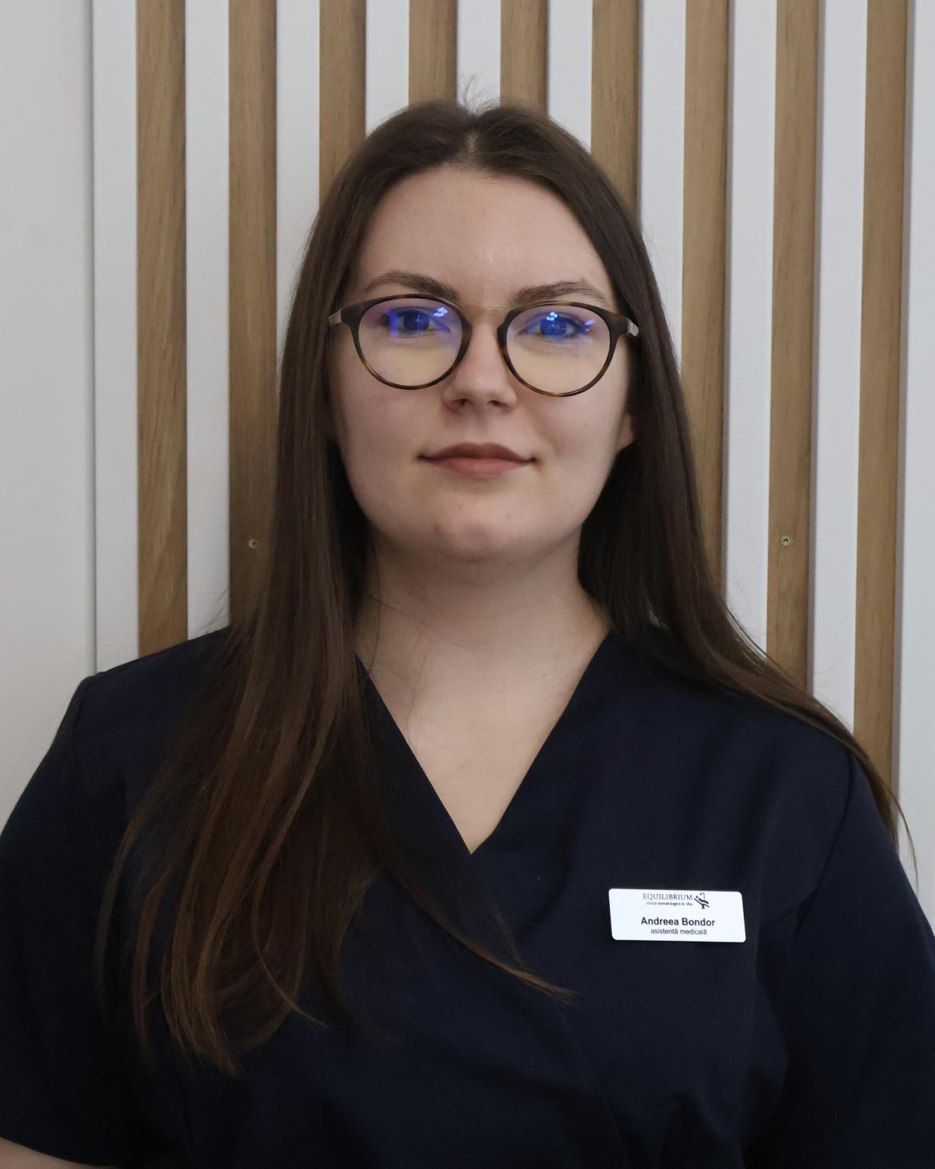 a woman in glasses looking at the camera