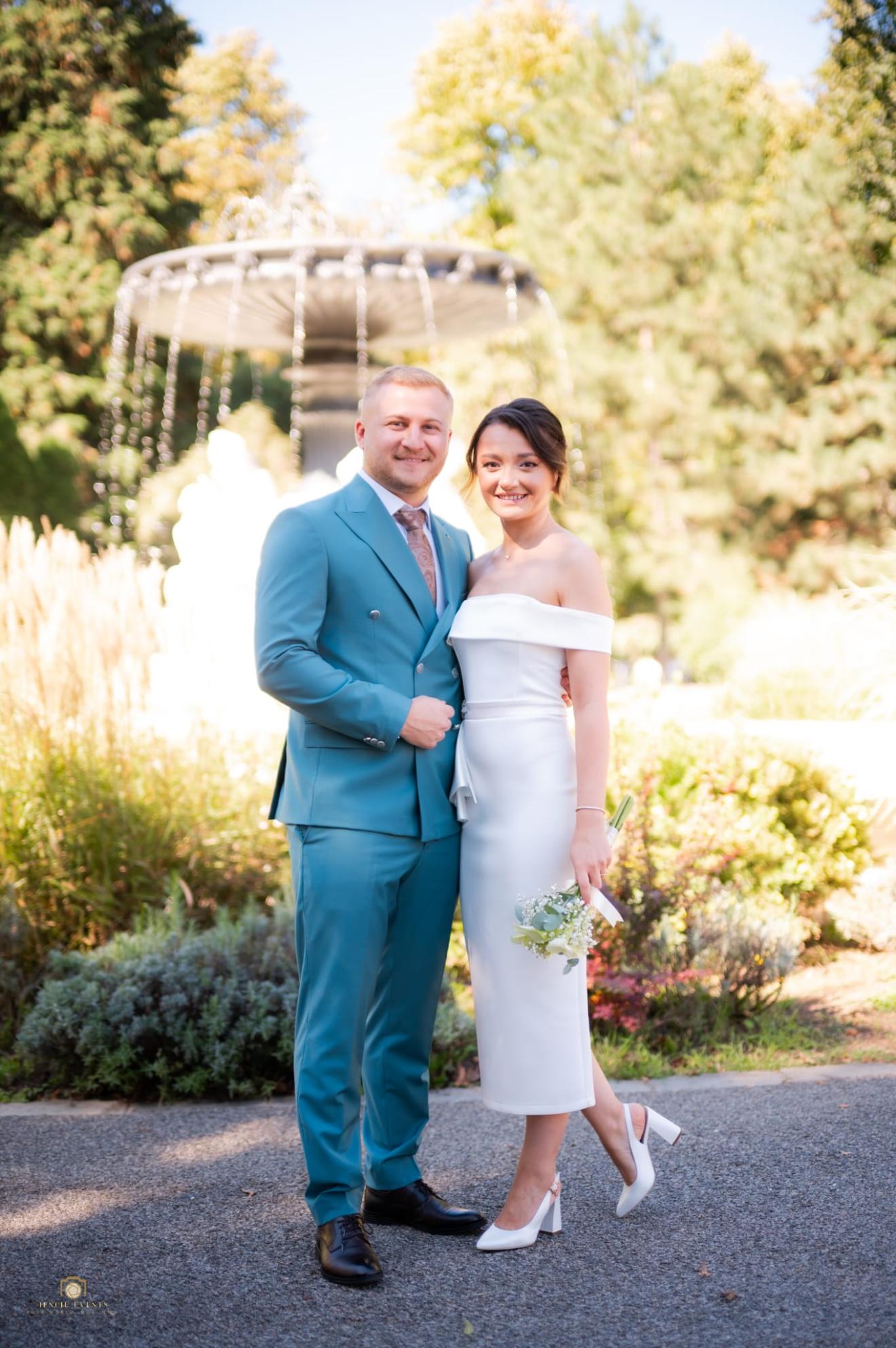 a man and a woman standing next to a road