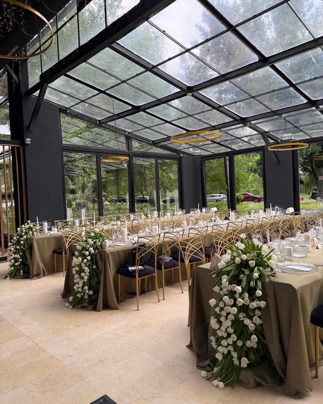 a room filled with furniture and vase of flowers on a table